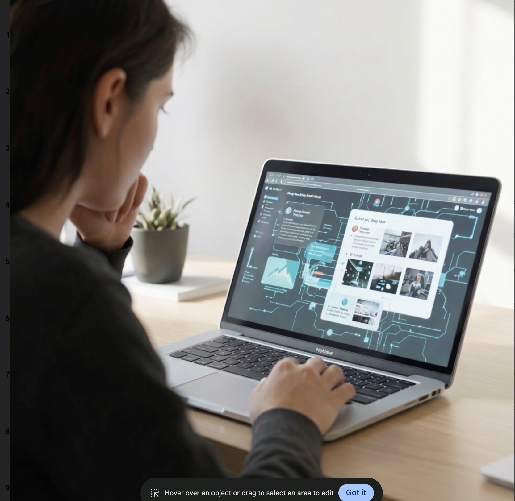 Someone sits looking at the images on a laptop and thinks, one hand under chin, and other hovering over the keyboard
